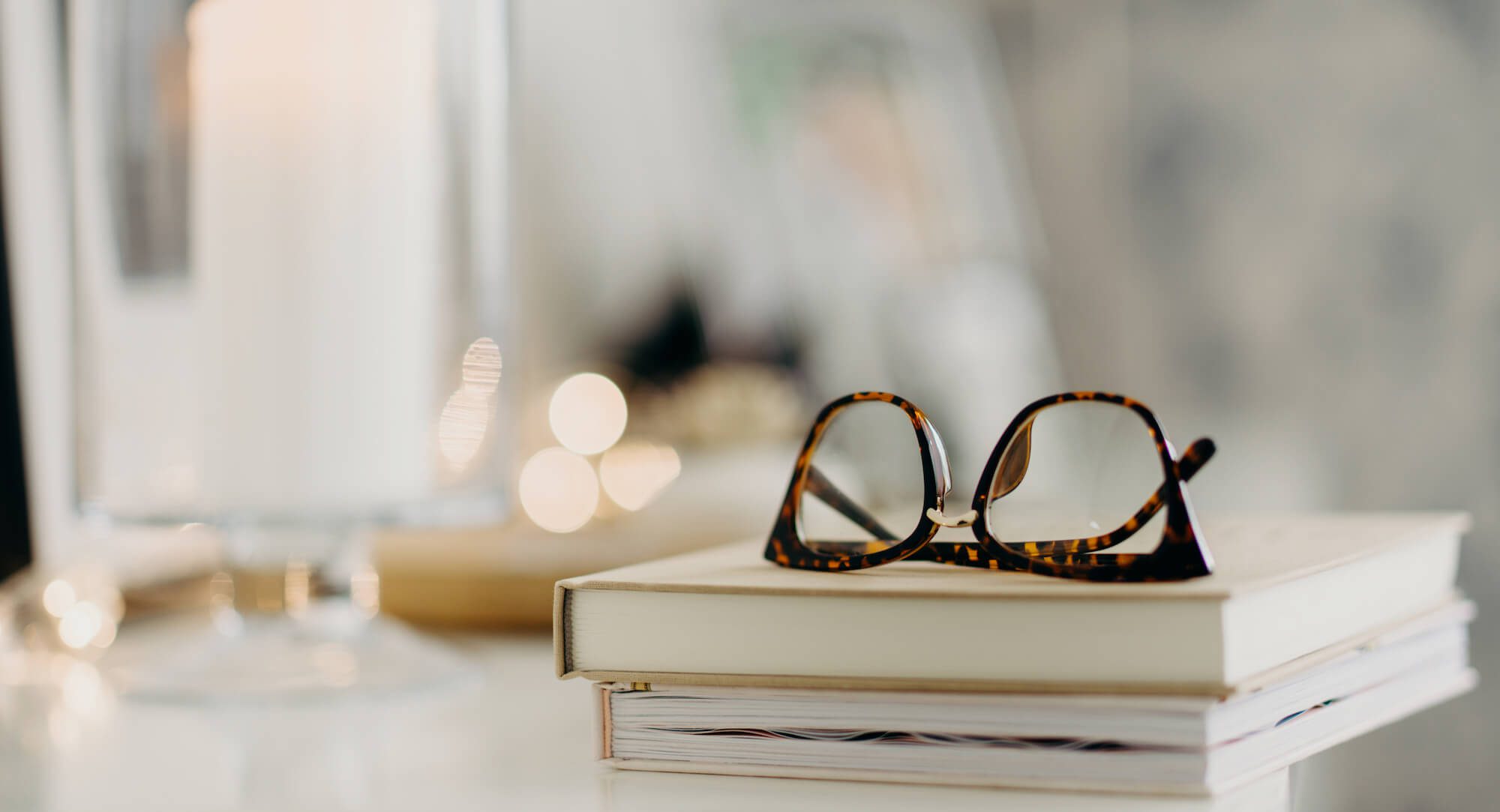 Pair of glasses on a stack of books